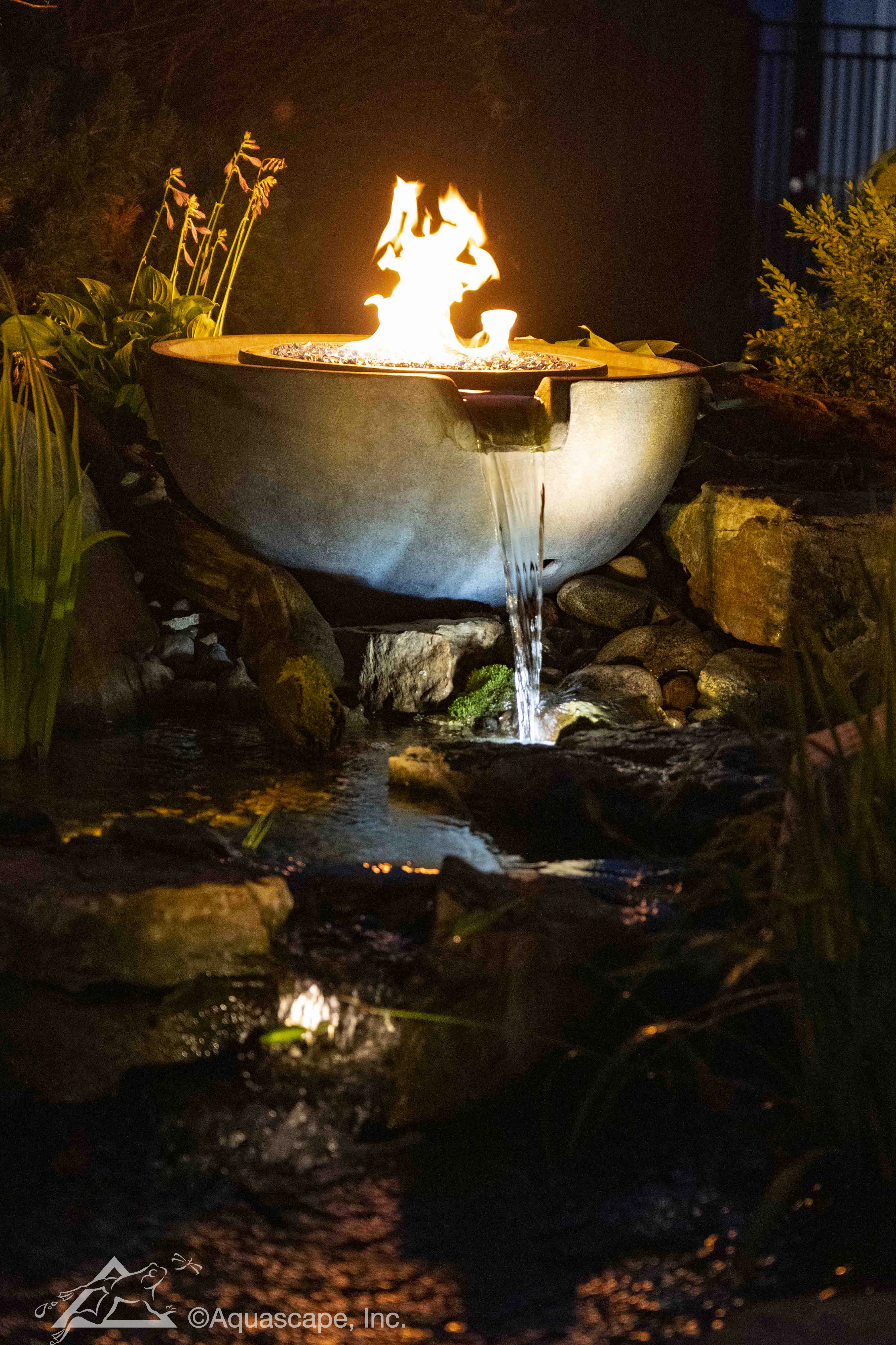 Nighttime fire and water spillway bowl feature in Apple Valley Minnesota