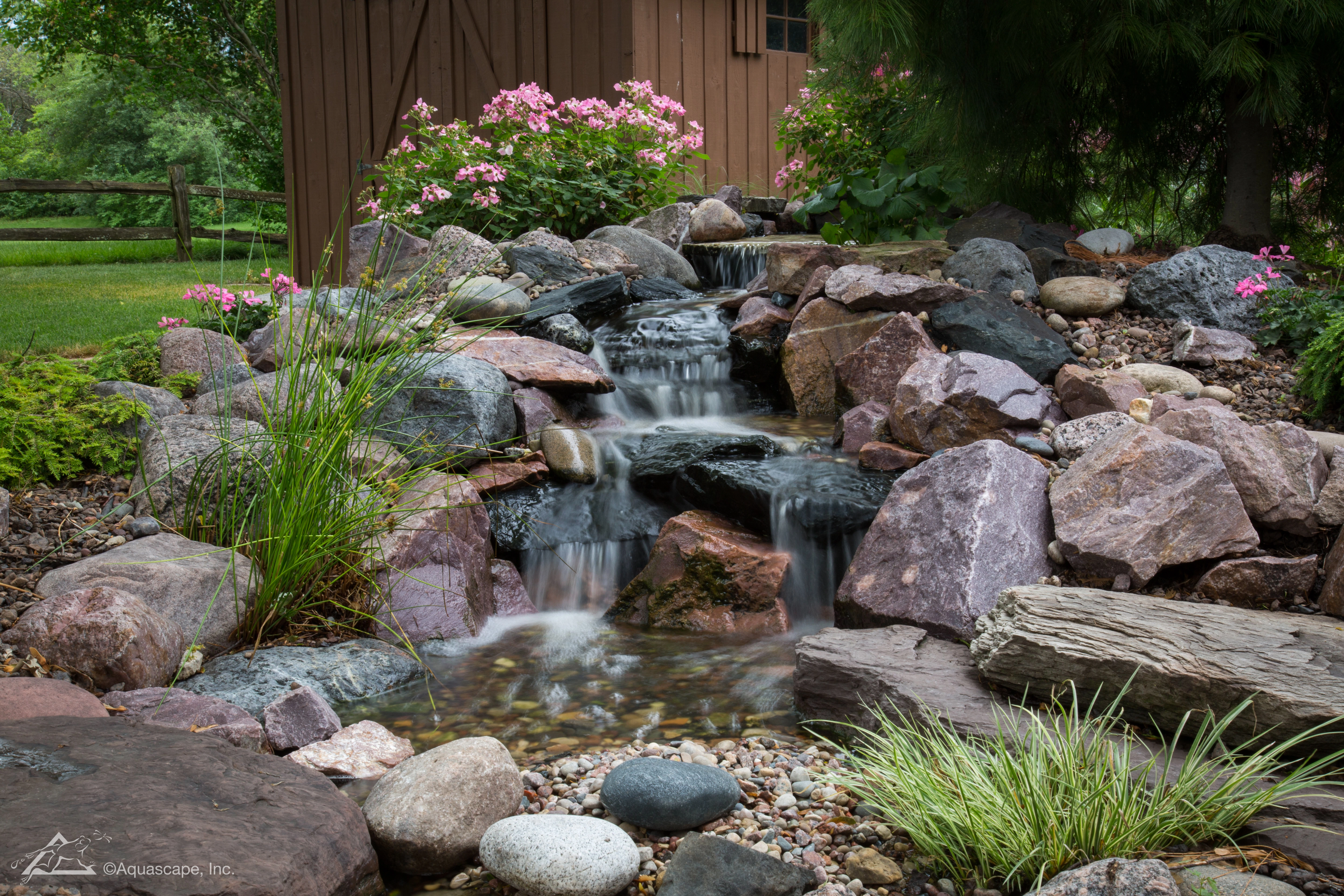 Small pondless waterfall with natural stone in Apple Valley Minnesota