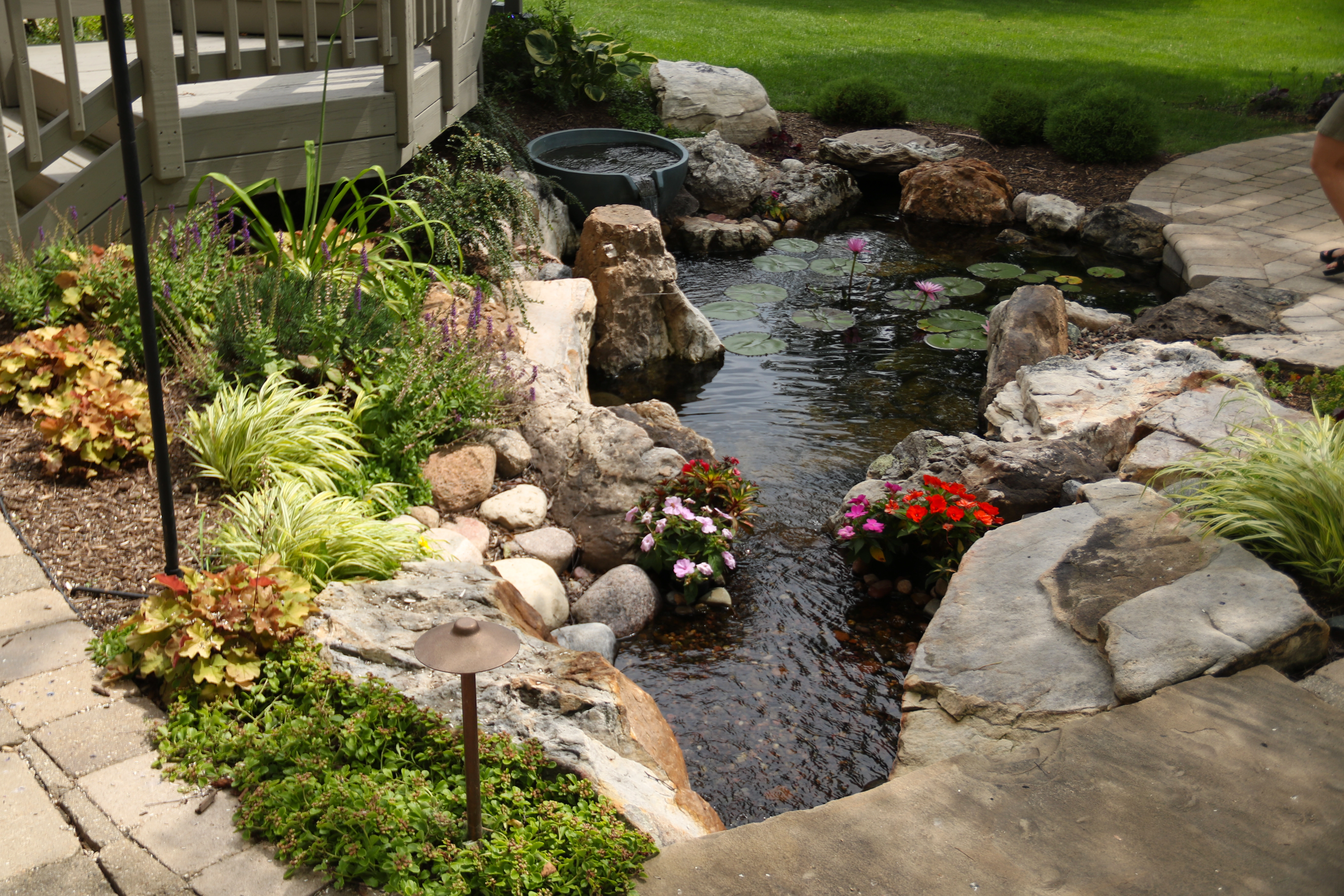 Water feature integrated between two existing patio areas