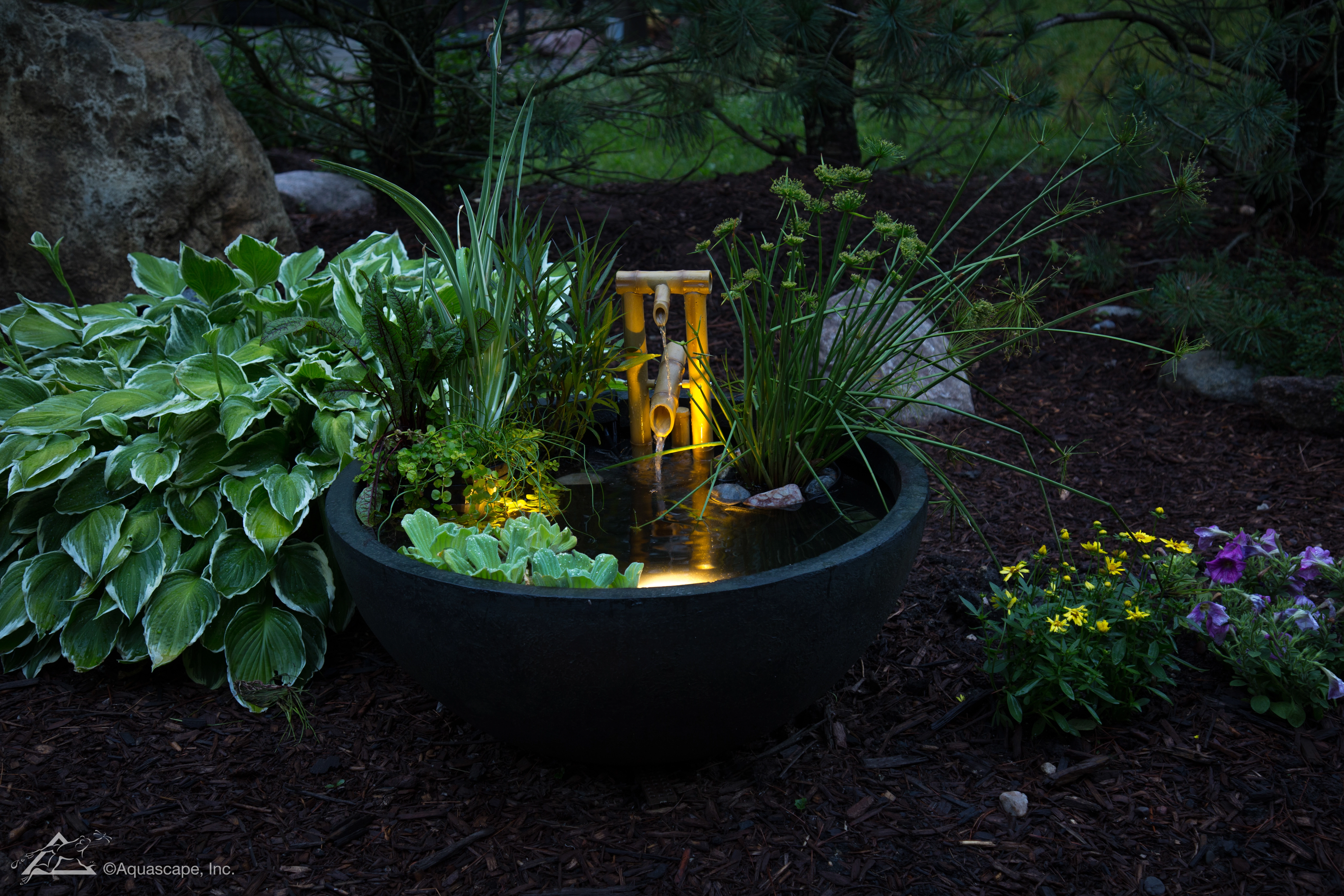 Small patio water feature illuminated at night