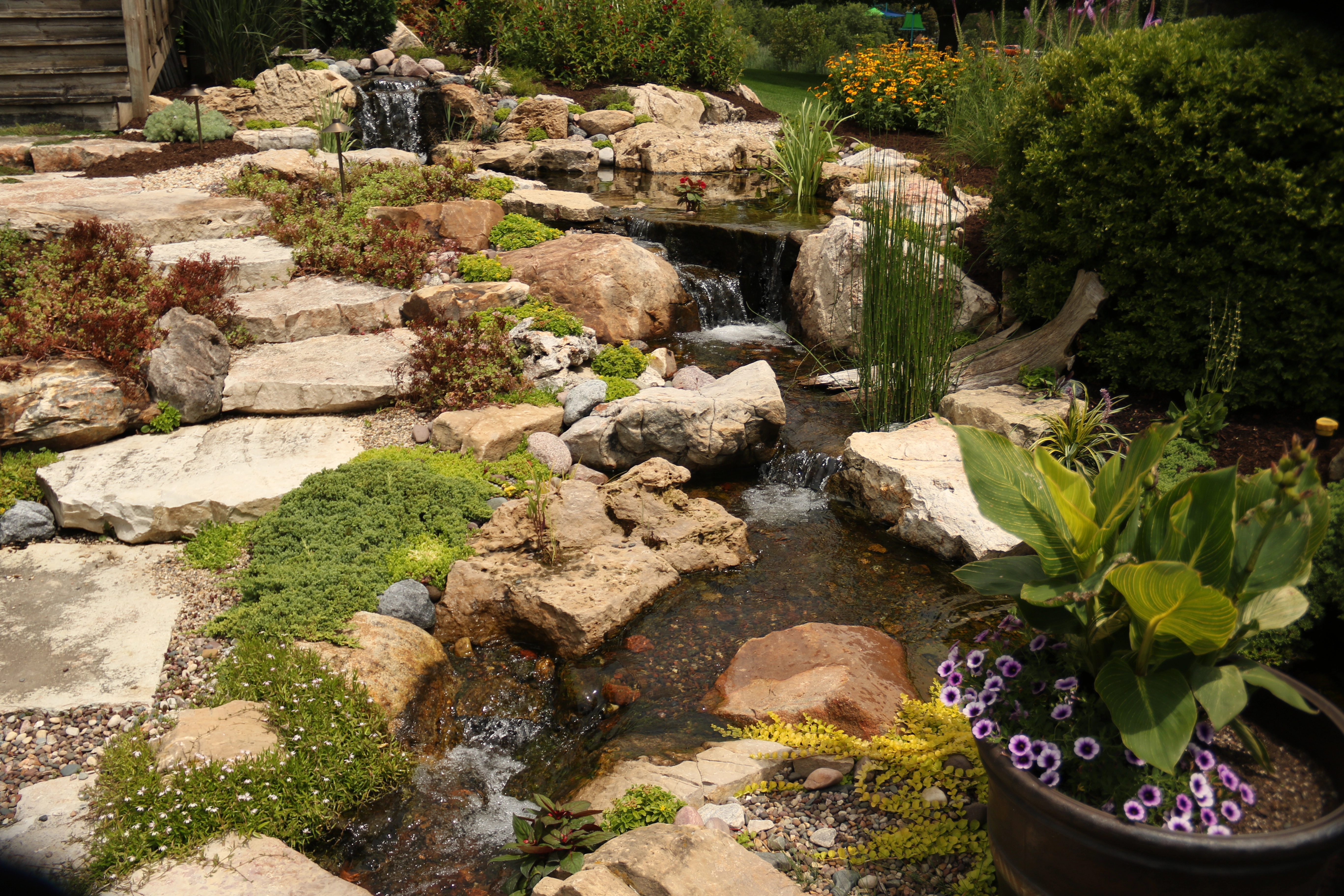 Natural pondless waterfall with stone and stream in Faribault Minnesota