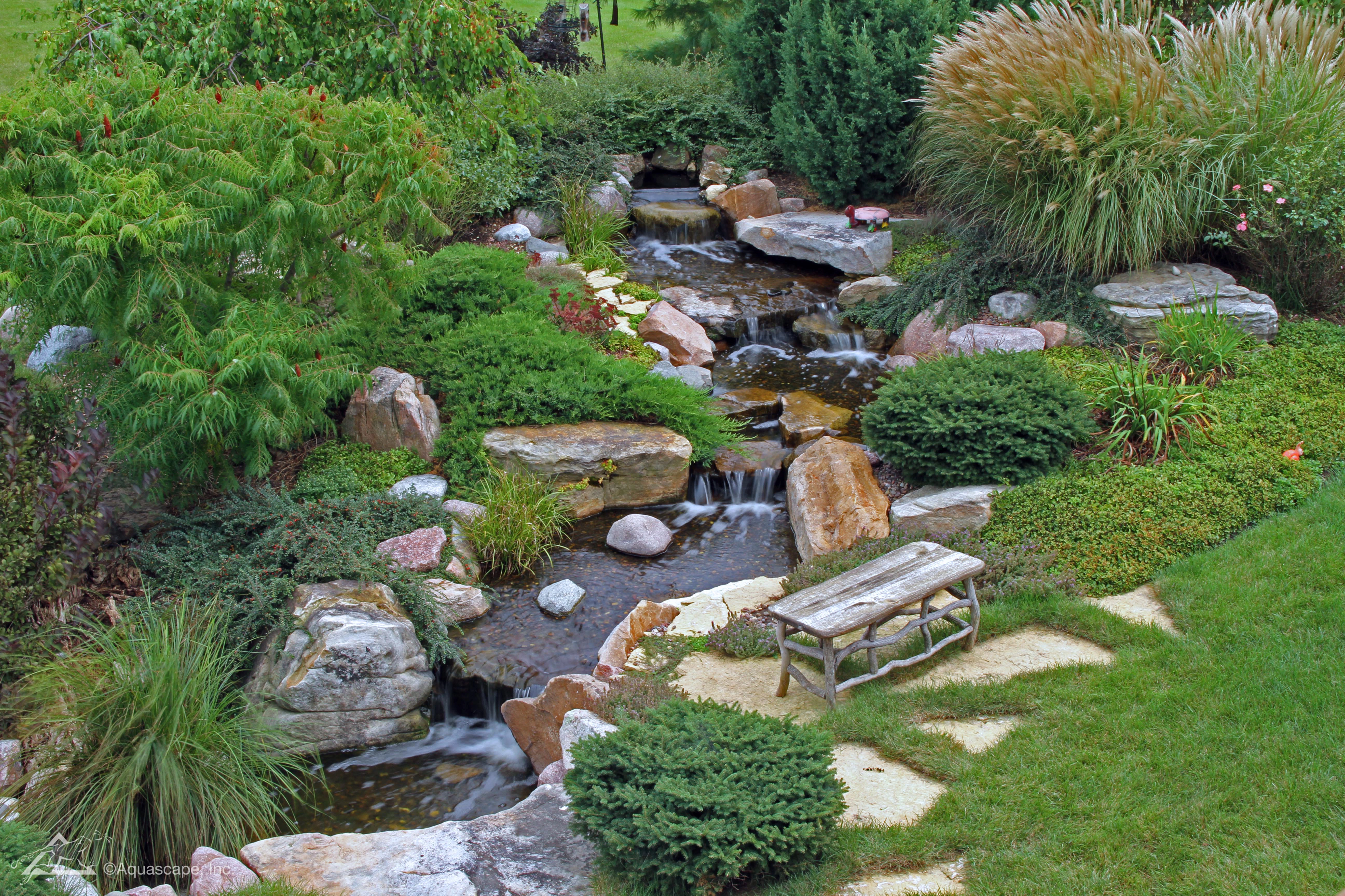 Custom pondless waterfall and landscaped backyard water feature near Farmington Minnesota