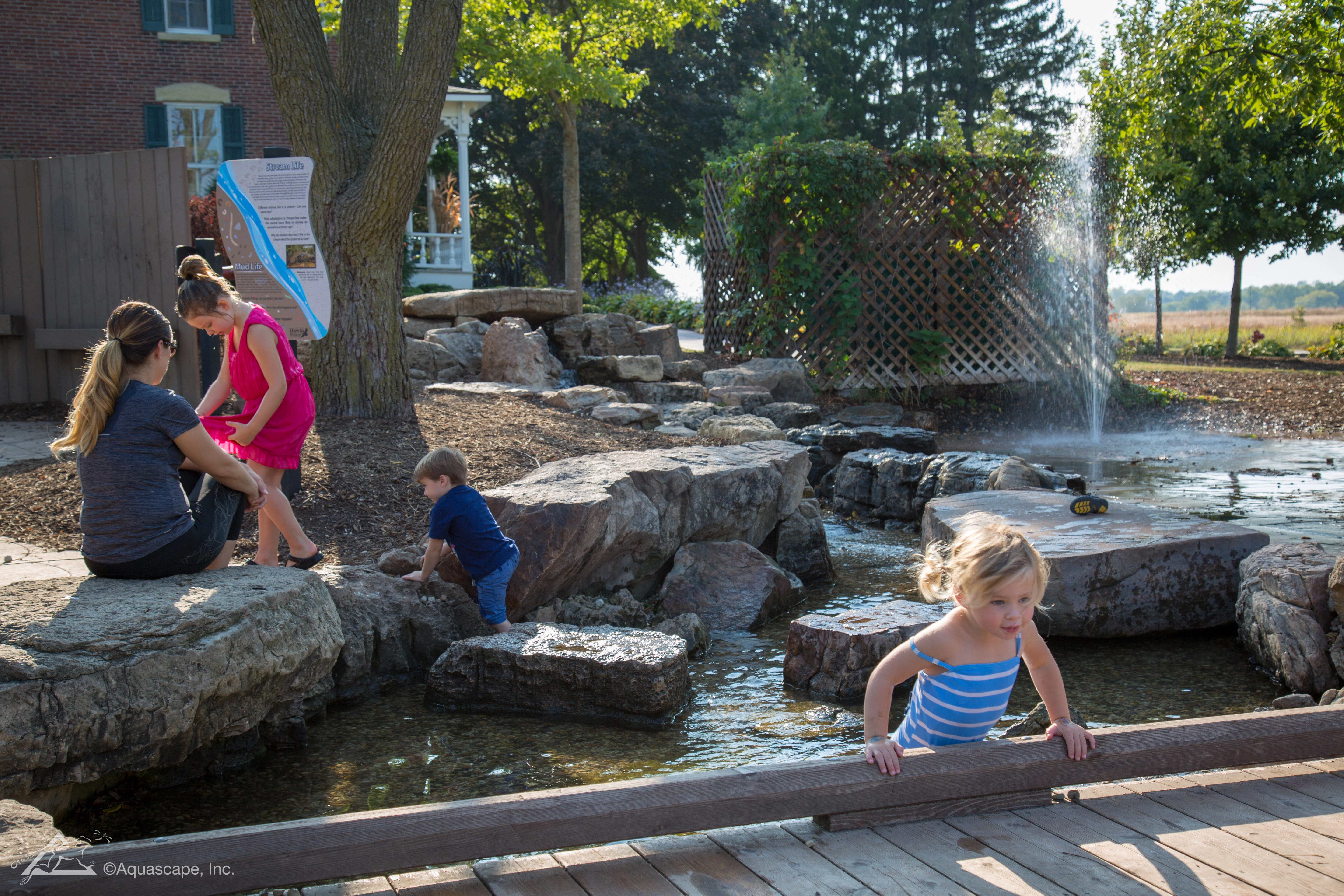 Family enjoying a water feature and pond in Inver Grove Heights Minnesota