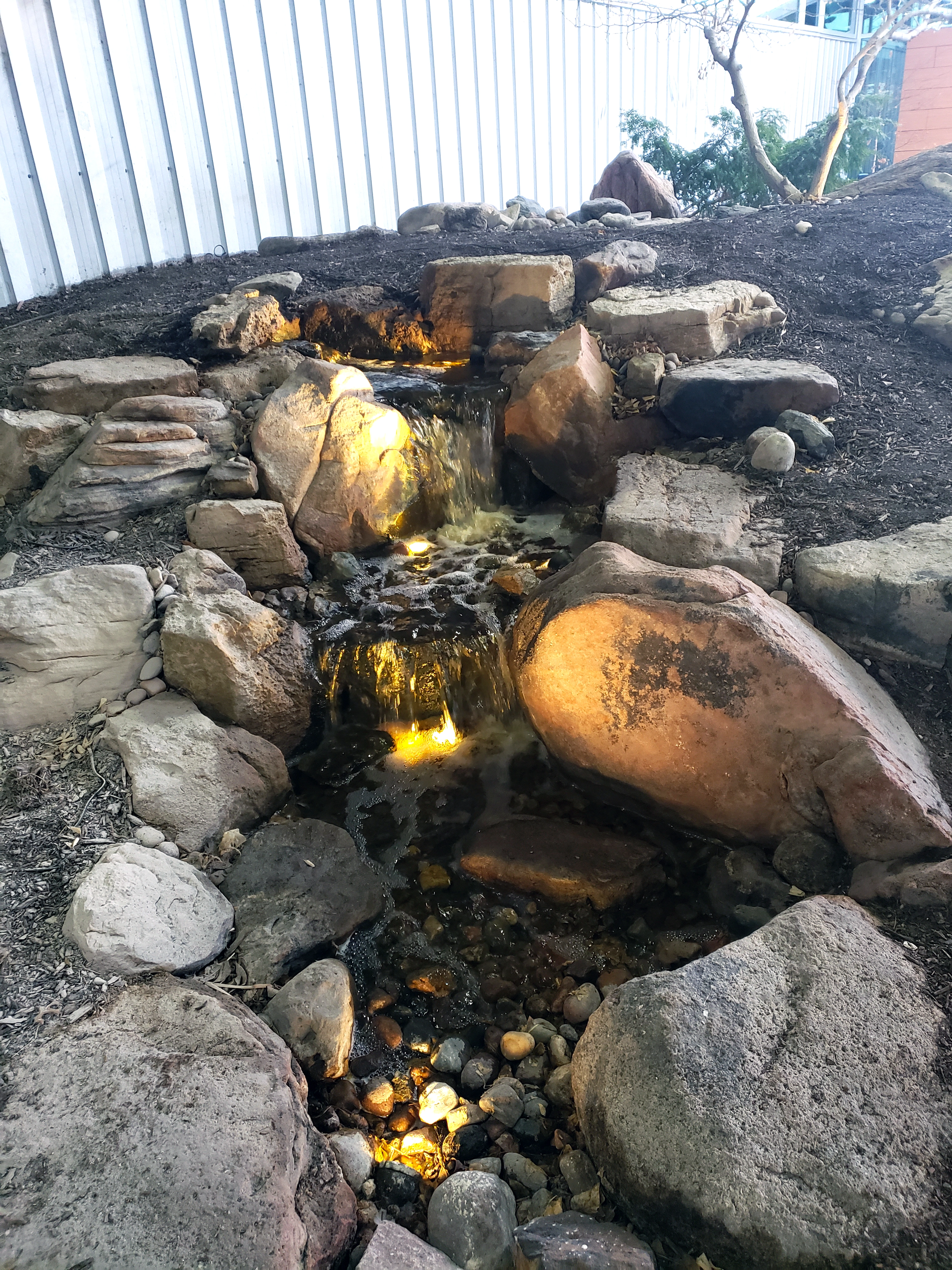 Pondless waterfall with lighting for a Lakeville Minnesota backyard