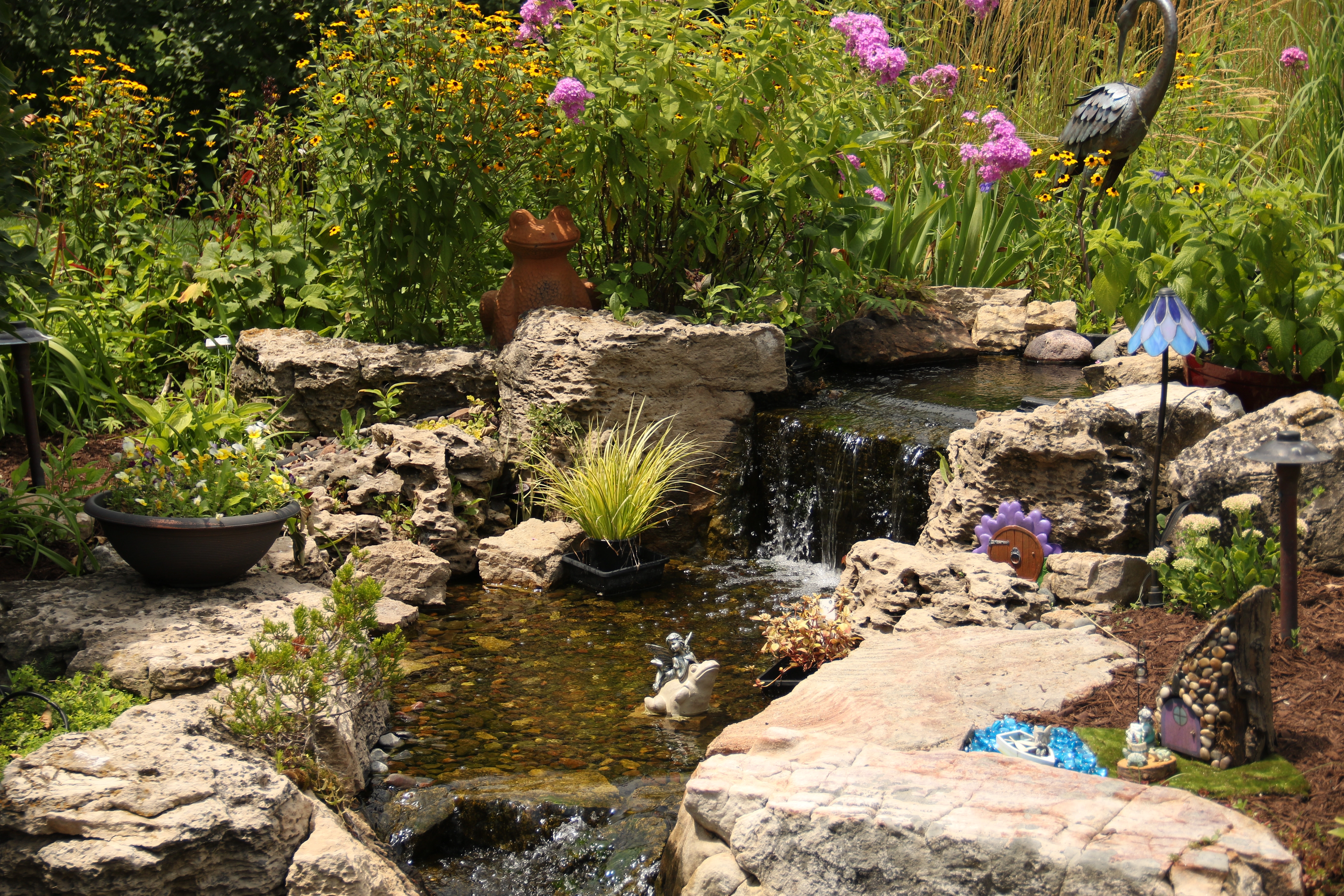 Natural waterfall and stream water feature designed for a Mankato Minnesota property