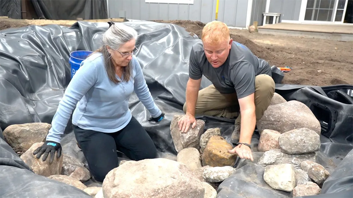 Rock and gravel installation during ecosystem pond construction