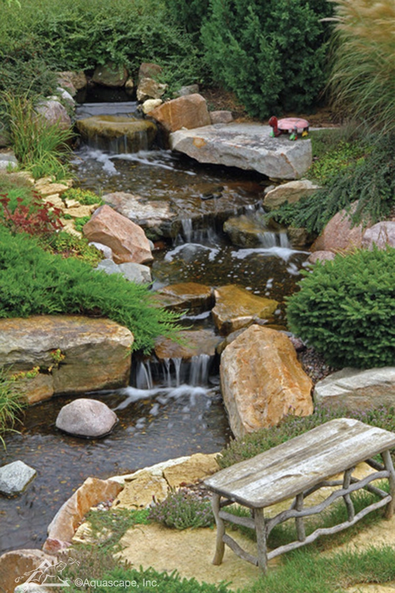 Large pondless waterfall with natural stone and planting in Redwood Falls Minnesota
