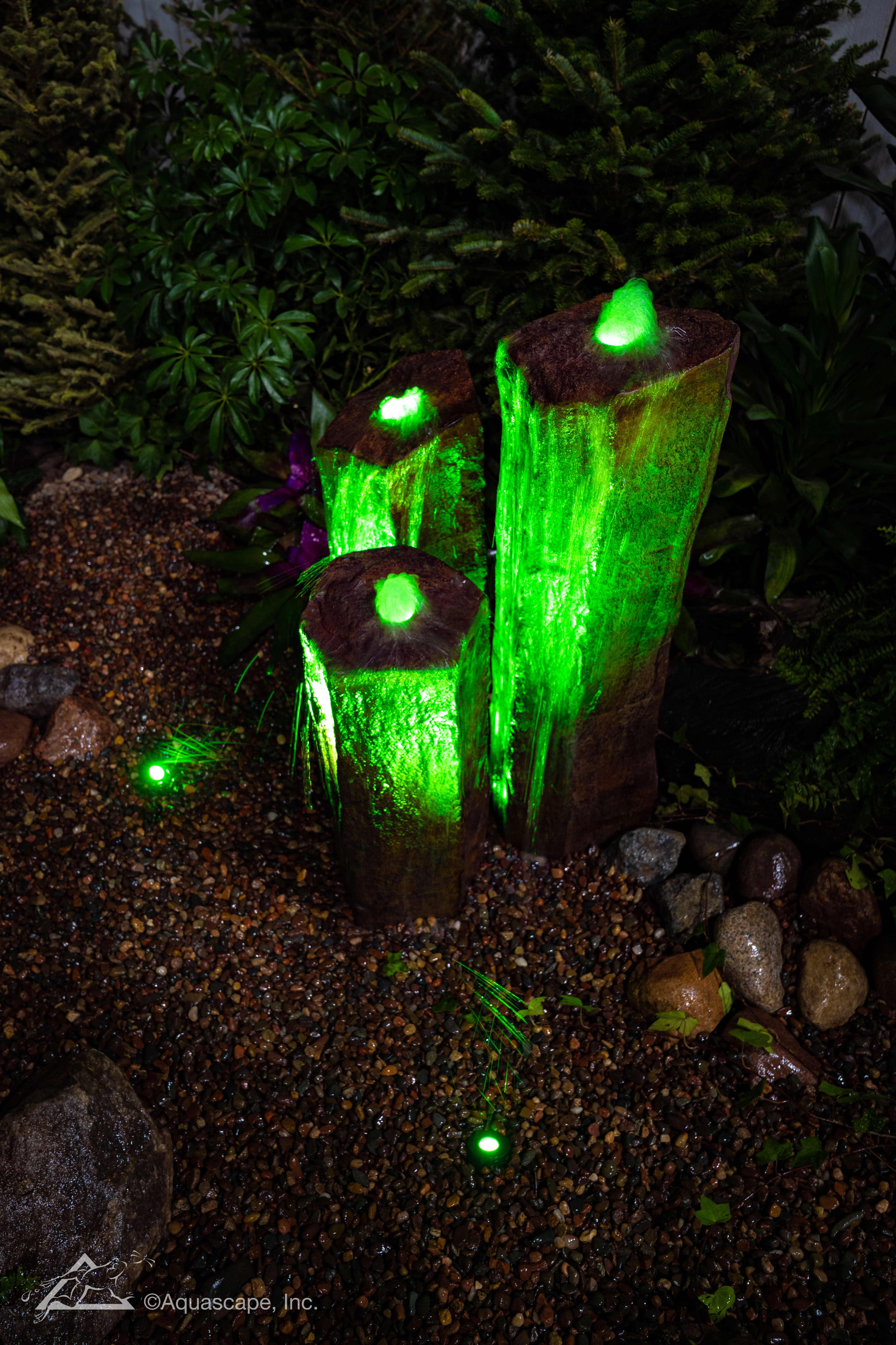 A trio of green-lit basalt columns