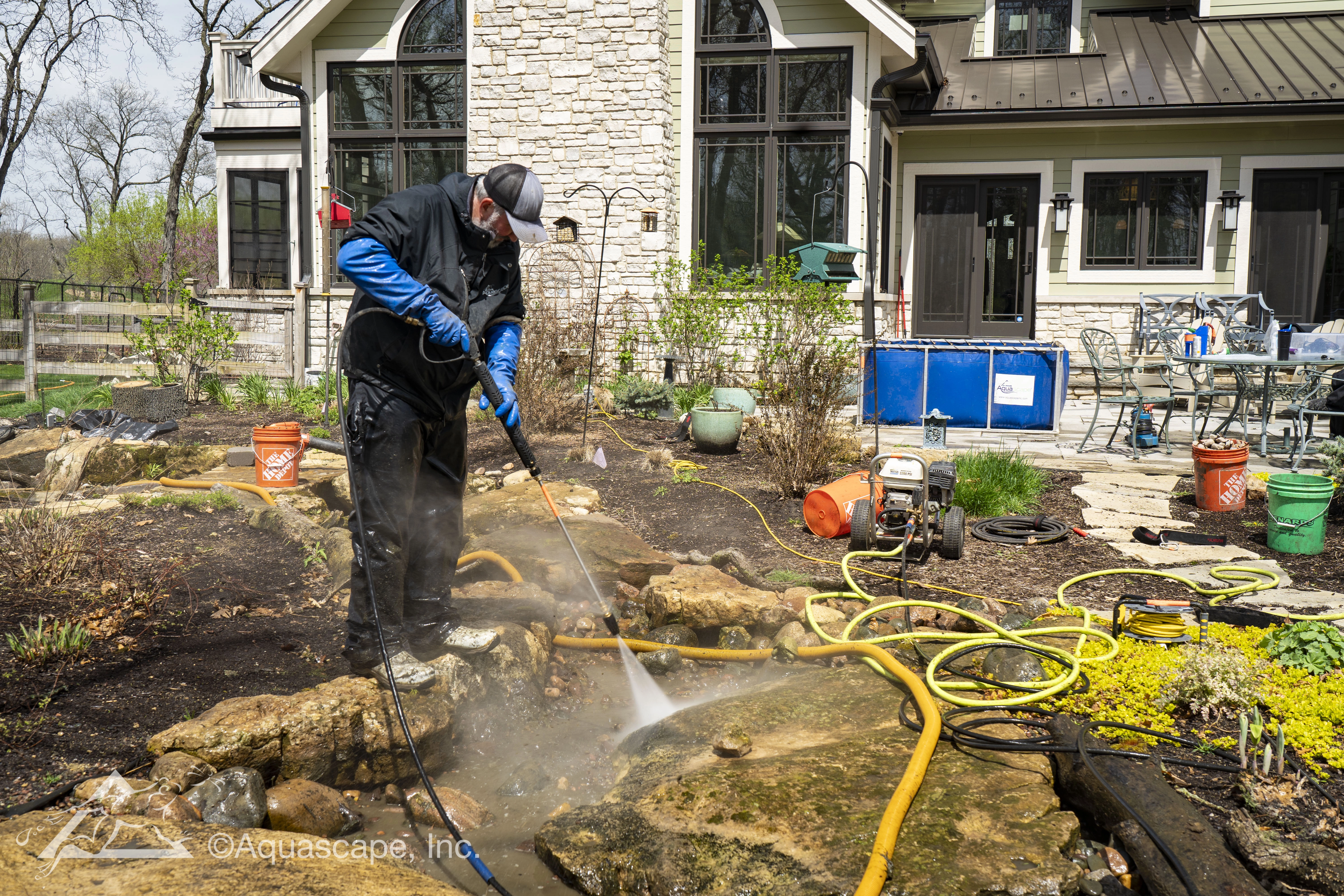 Powerwashing the rocks during a spring cleanout