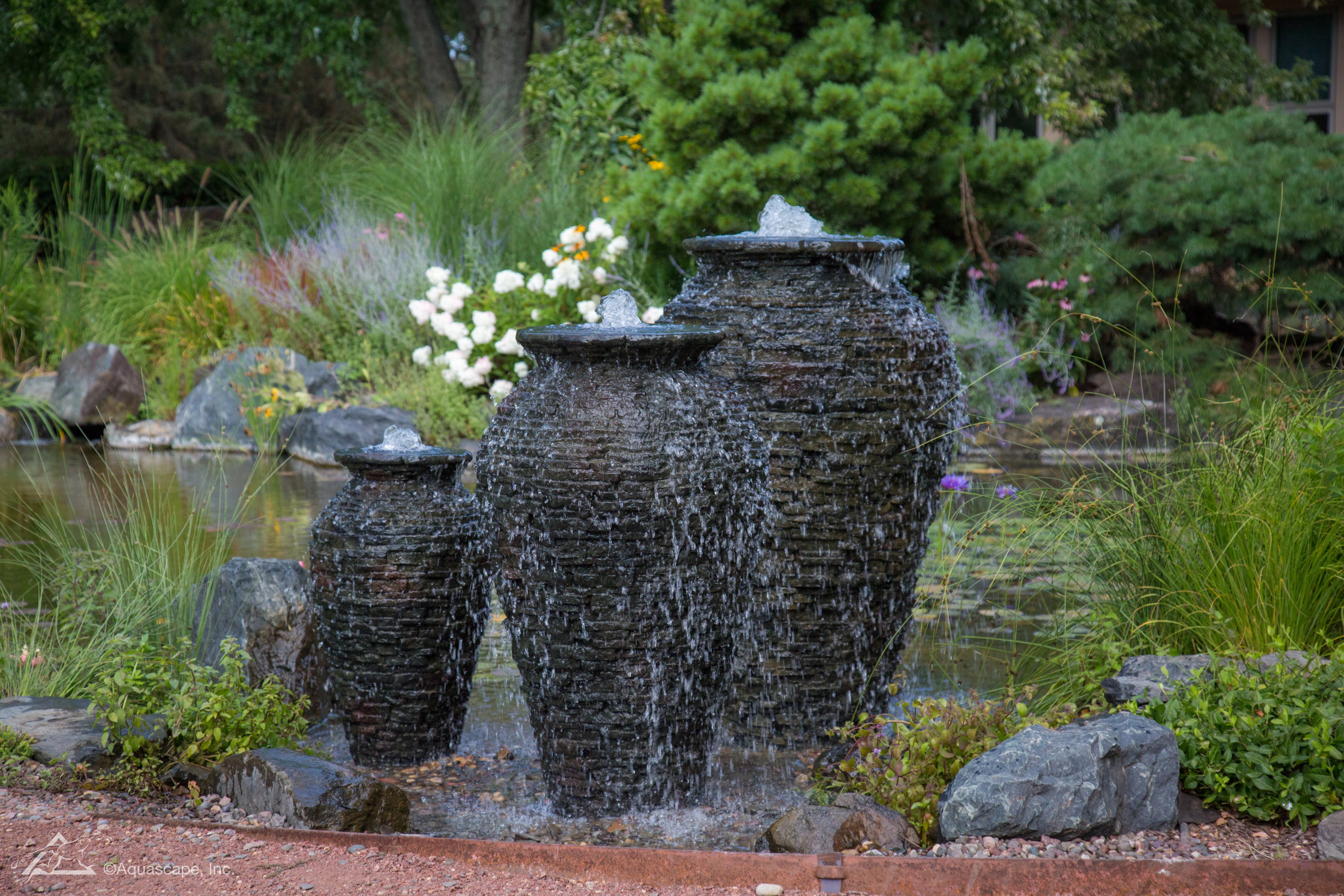 Stacked slate urn fountainscape in a Shakopee backyard landscape