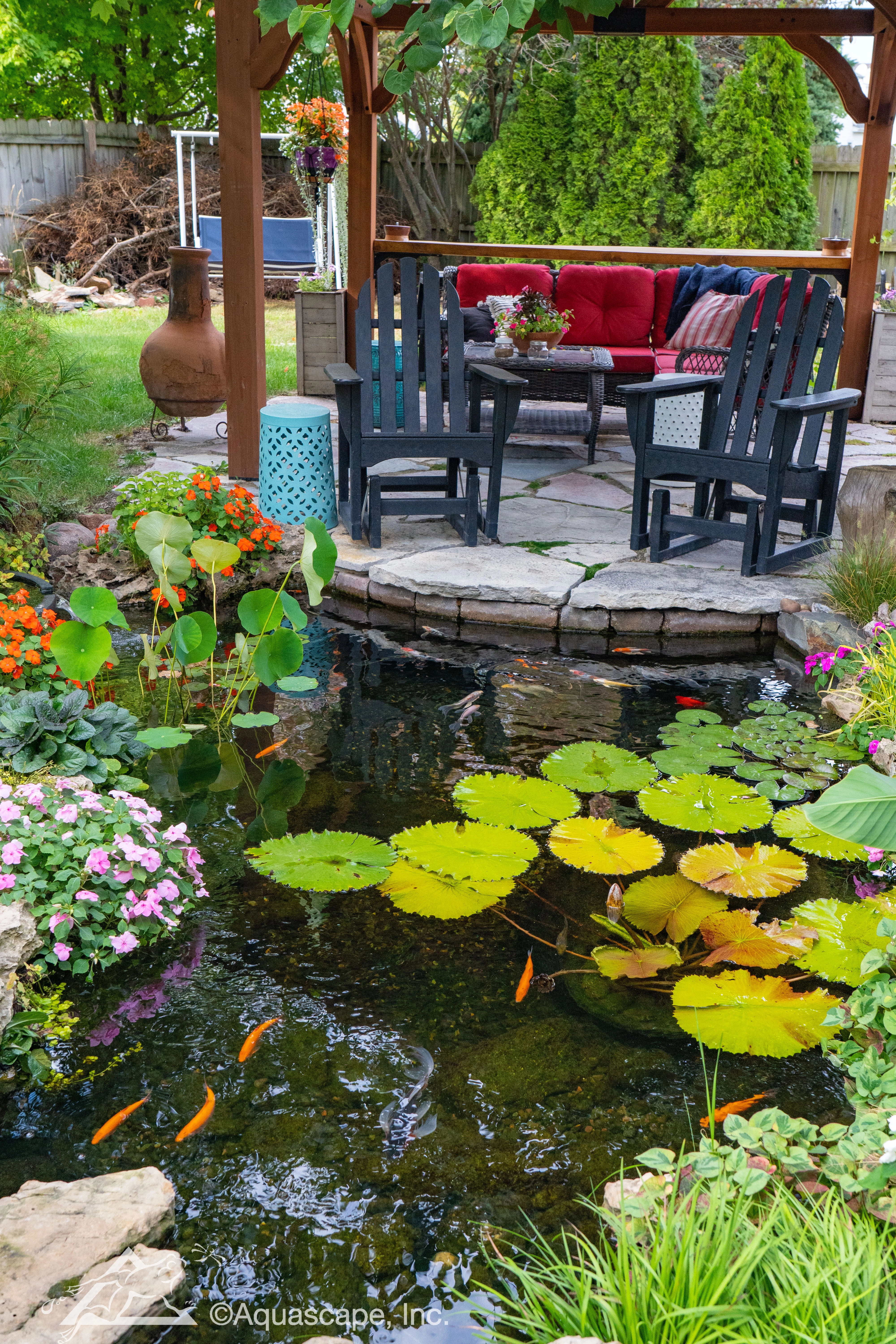 Backyard pond with pergola seating area in St. Peter Minnesota