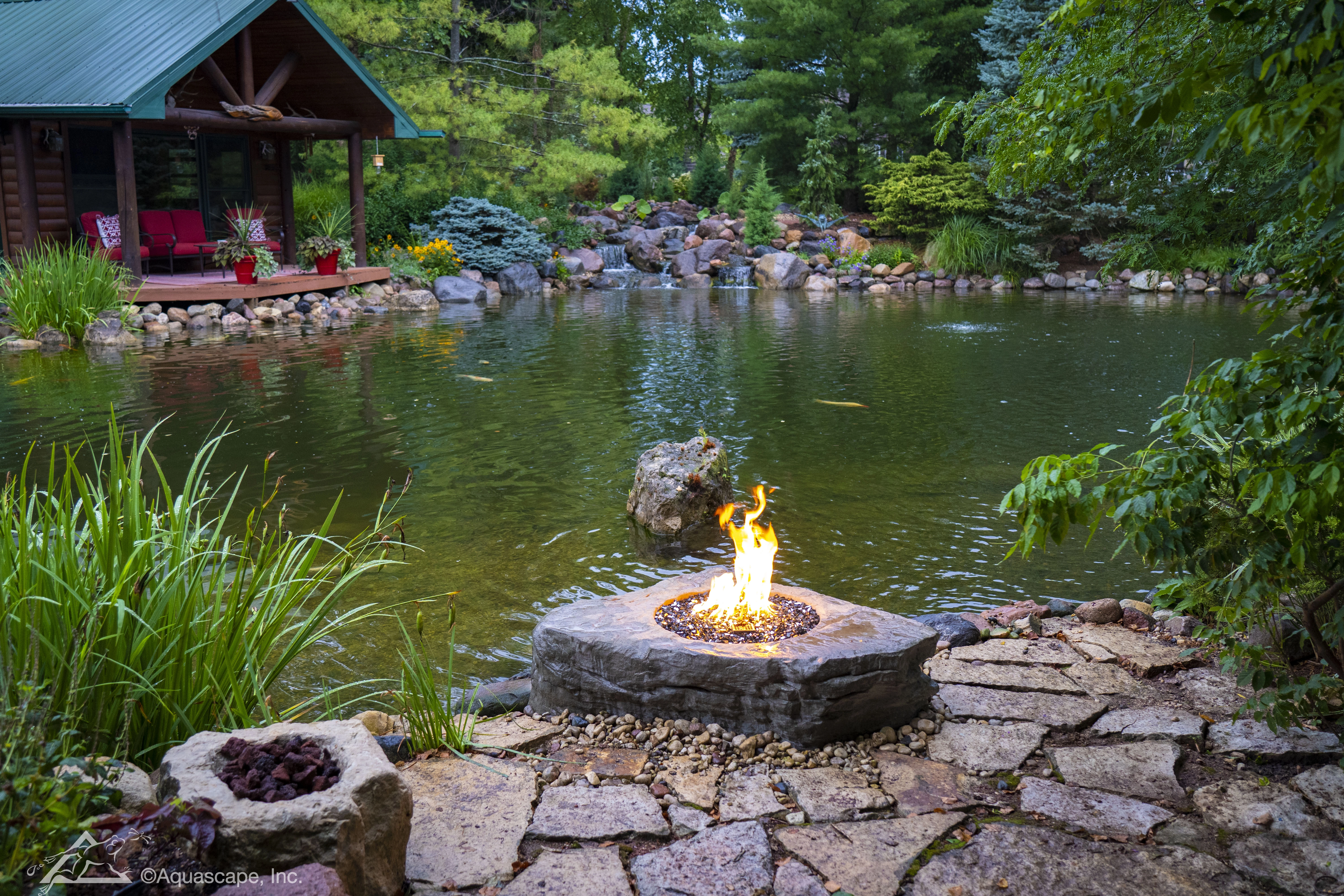 Evening firepit overlooking a pond and waterfall near Victoria Minnesota