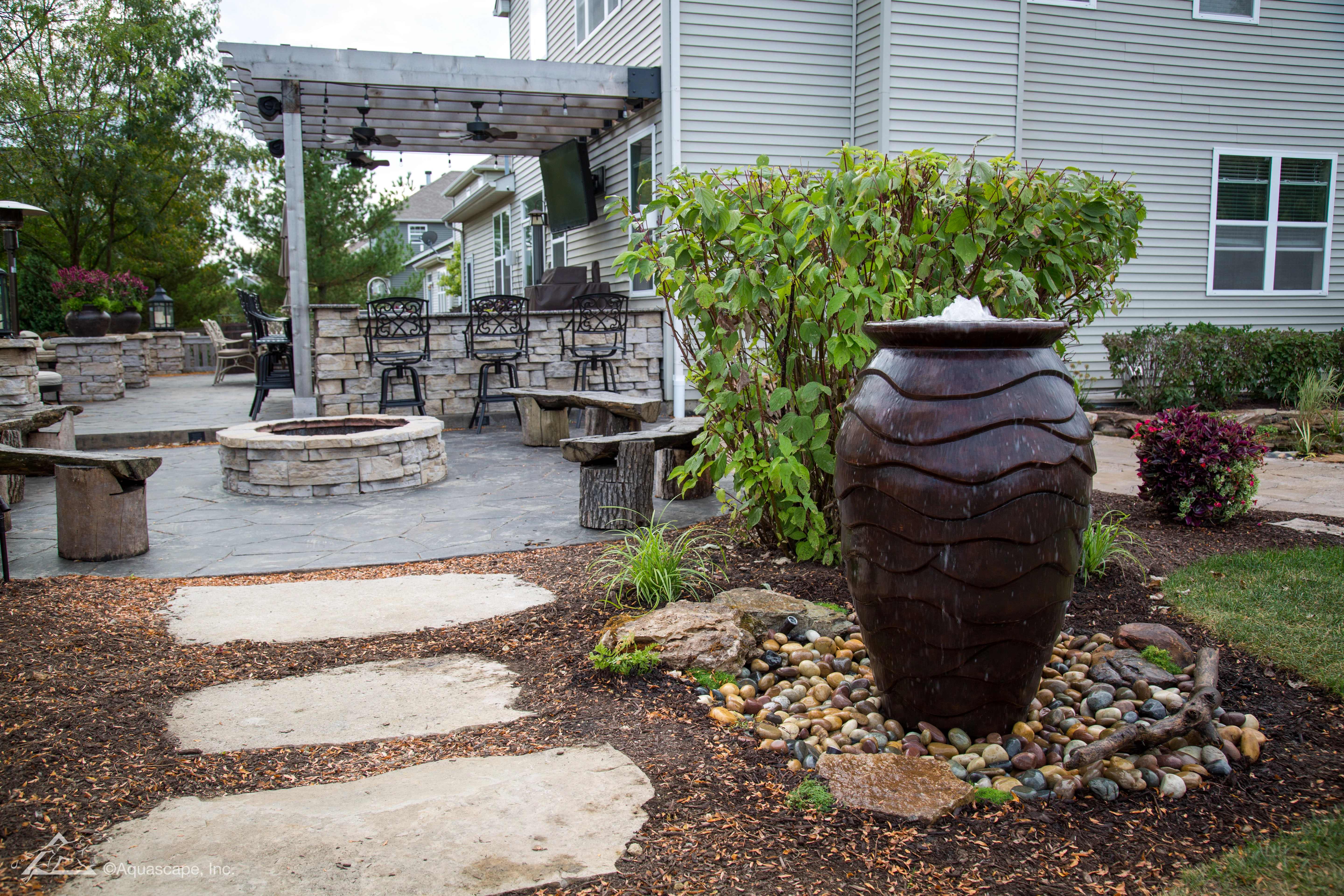 Decorative fountainscape near a patio and outdoor living space