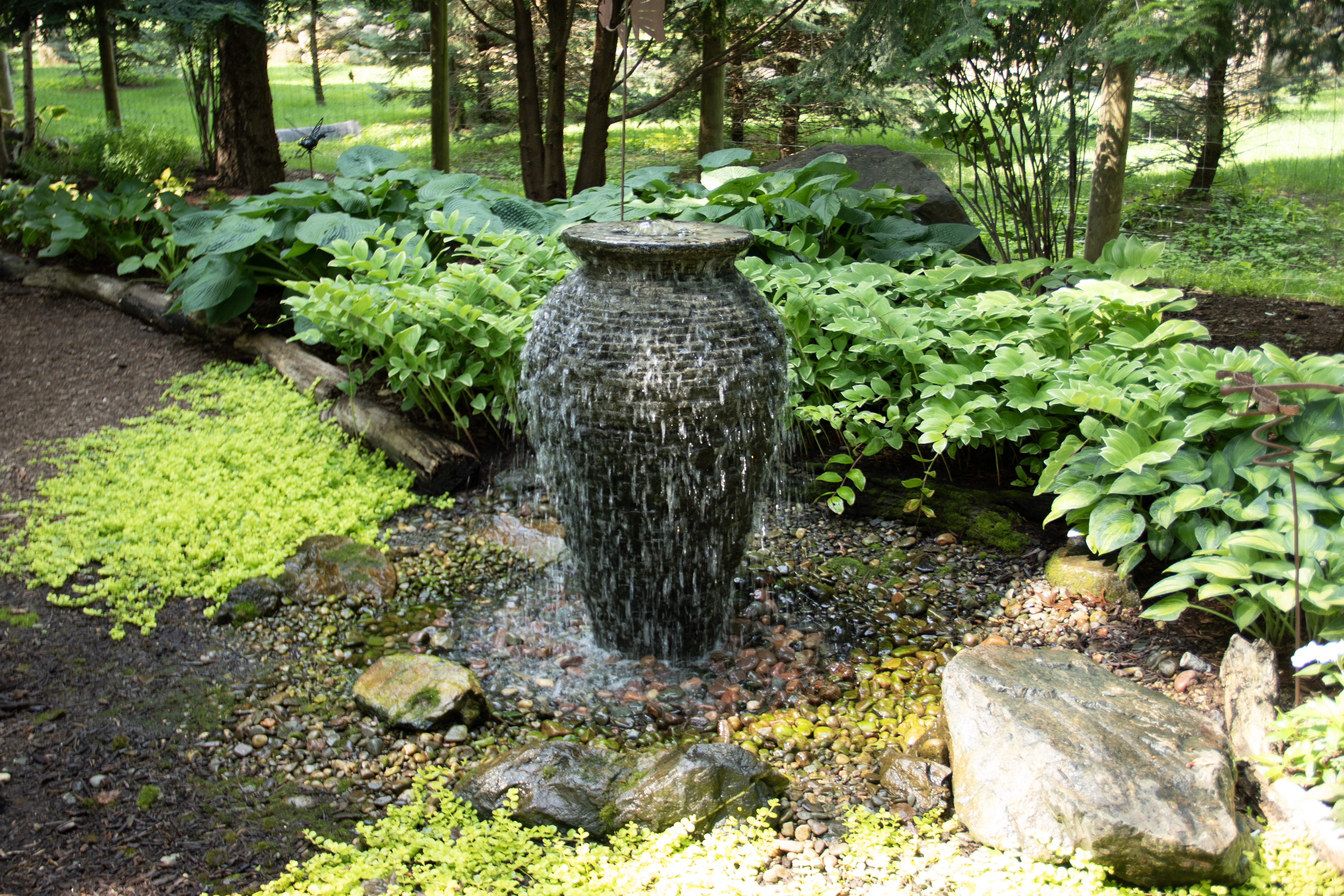 Decorative fountainscape with bubbling stone elements in a patio setting